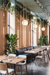 Modern west coast style restaurant with potted fiddle leaf fig trees, and vines hanging from ceiling.